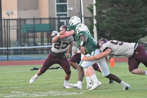 Maroon Devils defensive players Skeet Cook and Grady Lewis make it difficult for Charlotte Country Day to advance the ball in the opening season game last Friday. 