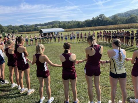 The women’s teams all joined together and linked hands for a group prayer before the race at Kituwah.