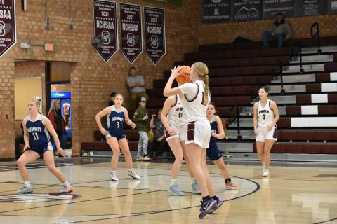 Emily Stargell takes a three-point shot in the home game against Summit.