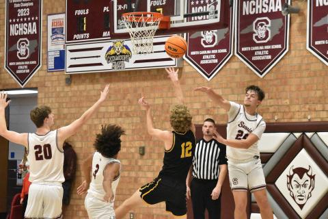 Maroon Devils from left Owen Medlin, Zeke Glaspie and Jon Stephenson all reach to recover the ball in the home loss against Murphy. 