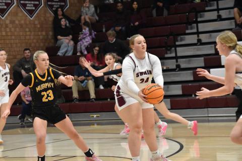 Faith Woodard, senior, hands the ball off to a teammate in the Murphy game. Woodard was recognized during Senior Night. 