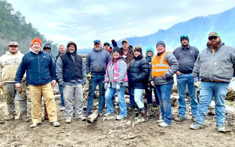 Photos by Sara Eisinger.  Event organizer Gina Wiggins stands front and center in a pink vest with members of Swain Clean, TVA and other volunteers at David Monteith Park Saturday, Feb. 22. Wiggins dedicated the cleanup effort to the late David Monteith.