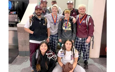 Swain sent two women and three men to the state wrestling championships this year. The athletes are pictured here with their coaches. 