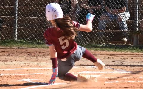 Photos/Joanna McMahan.  Freshman Hadley Shuler slides home at Murphy Tuesday, March 18. Shuler scored twice and supplied an RBI.