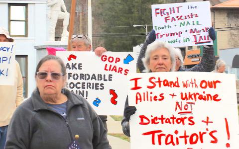 SMT Photo/Sara Eisinger.  Pam Pulley stands alongside former Republican Florida state Sen. Nancy Argenziano (2002-08), protesting recent administrative actions at the corner of Everett and Main streets on the afternoon of Tuesday, March 4. They rallied with members of Swain County Democratic Party and other supporters to “end executive overreach and uphold the Constitution.”
