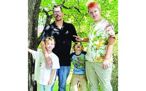 Submitted photo. Father Nathaniel “Scott” Jackson, 47, who died in the fire, stands with children Nathaniel Jr. (left to right), Anthony and Landon in a recent family photo.  