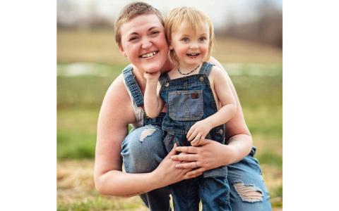 Photo/Kurstin Carroll.  Catie Hogue-Millard holds son Thatcher in celebration of his second birthday at Darnell Farms March 2. Husband Chevy Millard has been by his family’s side throughout his wife’s health problems.
