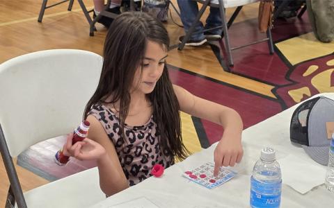 SMT photo/Sara Eisinger.  Ariana Kirkland, 6, plays Bingo with family and friends during this year’s Spring’O’ Bingo Night at the Swain Middle School gymnasium Saturday, March 29. The event raised more than $10,000.
