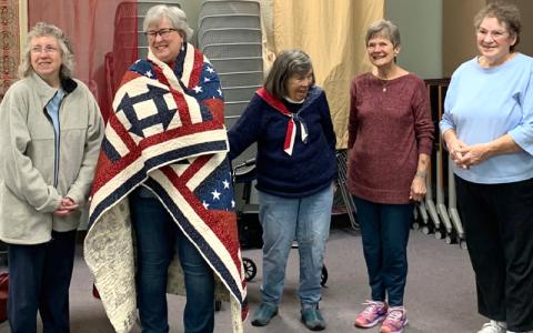 Submitted photo.  Lisa Towe (left to right), United States Navy Vet. Cynthia Womble, Maddie Haughn, Rosalind Ryan and Susan Roper at a Quilt of Valor ceremony to honor Womble’s 28-year military career at Marianna Black Library Tuesday, April 8. Womble retired as a Navy captain in 2017.
