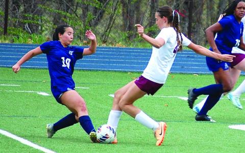 Photo/Brittany Blankenship.  Madison Blankenship challenges the ball against Asheville School Blues on Monday, March 31 . The Lady Devils took the 1-0 win. 