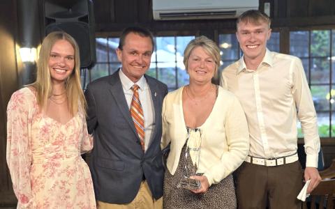 SMT photos/Sara Eisinger.  Neil and Sonya Blankenship celebrate winning the Duke Energy Citizenship and Service Award at the Swain County Chamber of Commerce Banquet at Fryemont Inn Thursday, April 24 with children, Arizona (left) and Cameron (right). Neil and Sonya Blankenship retire from Swain County Schools this year.