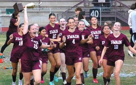 Submitted photo.  Karena Cline carries the Smoky Mountain Conference trophy alongside teammates after winning the conference championship Monday. The Lady Devils completed an undefeated season in SMC play, improving to 12-0 in the conference and 15-1 overall.