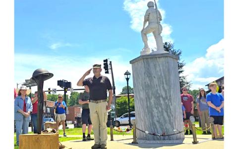 SMT photo/Sara Eisinger.  Vaughn Benner, retired US Army chaplain, pays tribute to fallen soldiers during a remembrance ceremony at the memorial monument in front of Swain County Visitor Center and Heritage Museum on Monday afternoon. Benner delivered the invocation and benediction.