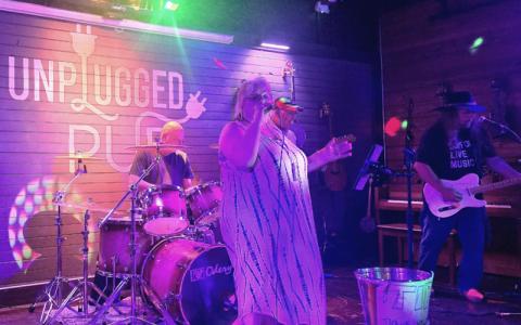 SMT photo/Sara Eisinger.  Lori McDonald of Lori and the Freightshakers plays its last song on the Unplugged Pub stage Saturday, May 24. Last weekend marked the end of a four-and-half-year era.