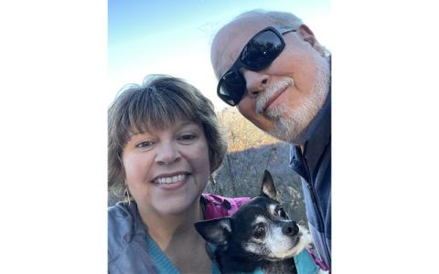 Submitted photo.  Danny Weber and Jennifer Odom Weber love on their dog, Tiger, at Highlands N.C. in Nov. 2023. Jennifer Odom Weber lives with Lupus. 