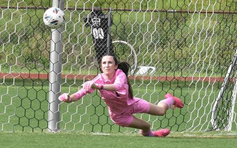 Photo/Joanna McMahan. Senior goalkeeper Gracie Sutton makes a diving save in goal against Bethany Community School Wolves at home Thursday, May 15. Gracie topped off her high school career with one of her best games.