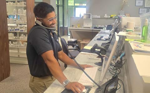 SMT photo/Sara Eisinger.  Pharmacist Ameer Adam, owner of Mark’s Pharmacy, opens at the Valley Village Shopping Center Monday, June 16. Business started slow but transfers soon flew in. 