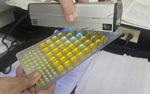 SMT photo/ Sara Eisinger. Water Treatment Plant Supervisor Russell Ball displays raw water samples from the lab Monday, July 14. Yellow indicates Chloroform and the black light indicates E.coli, which is why Ball advises people not to drink raw river water. 