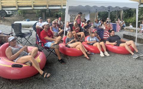 Submitted photo.  Tubers listen to live music at Deep Creek Lodge and Tube Outpost in July 2025. The lodge will host its second running free Deep Creek Community Day this weekend.