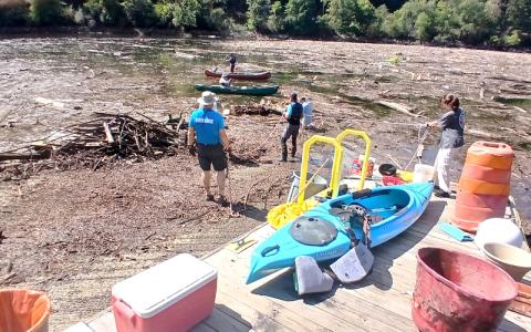Photo/Nick Nichols.  Volunteers cleanup around David Monteith County Park boat launch after Hurricane Helene last year. 