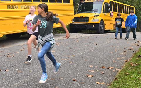 SMT photo/Sara Eisinger.   Mountain Discover Charter School students, K-8, run around the quarter mile “school loop,” up its 100-foot incline and back down, to raise money for instructional supplies Monday.
