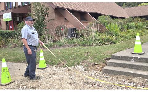 SMT photo/Sara Eisinger.  Mike Tabor, Town of Bryson City street supervisor, helps remove the tree and root system from Bryson City United Methodist Church Oct. 7.