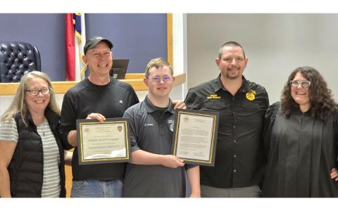 SMT photo/Sara Eisinger.  Windy (left to right), Scott and Owen Kribs after swearing in as a Swain County Sheriff’s deputy with Sheriff Brian Kirkland and District Court Judge Kristy L. Parton Oct. 3.