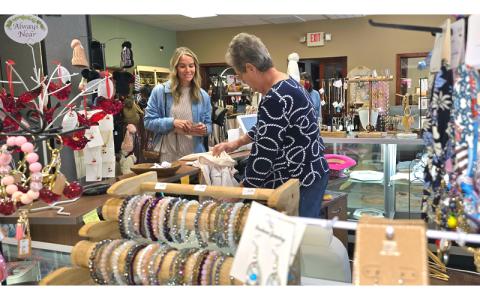 SMT photo/Sara Eisinger.  Joan Bailey sells customer Leah Frazier apparel at Pursenality Marketplace Oct. 11. 