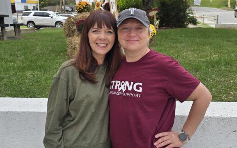 SMT photo/Sara Eisinger.  Sisters Mary Parton and Dawn Dills are closer than ever outside the Swain County Administration Building Sept. 30. Dills received help from Swain Cancer Support along her path to cancer remission. 