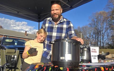 Photo/Sara Eisinger.  Jason Foster hugs his little girl, Fern Foster, during the chili cook-off at The Grove Church Saturday. 