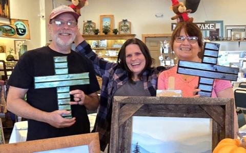 SMT photo/Sara Eisinger.   Howard Baker (left to right), Melissa Owen and Donna Baker have fun at Art Explorations of WNC on Nov. 20. Donna and Howard Wood Design is one of 16 vendors with art for sale at the studio. 