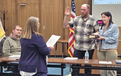 SMT photo/Sara Eisinger.   Swain County Clerk of Courts Misti Jones swears Jason “Jay” Kirkland in as Chair of Swain County Board of Commissioners, alongside his wife, Aleisha Kirkland, Tuesday, Nov. 4.  