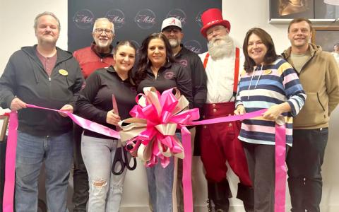 Photo/Sara Eisinger.  Toby Allman (left to right), Mike Drinkwater, Kenzie Cochran, Michelle Cochran, Tony Cochran, Tim Marks, Monica Brown and Ricky Sanford celebrate the opening of Portraits by Michelle in a ribbon cutting ceremony Nov. 13