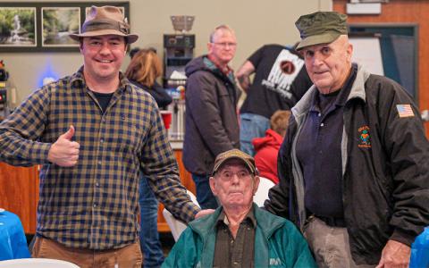 Photo/George Carter. The oldest veteran in the room, United States Army veteran Edwin Shook, received the honors of cutting the 250th Marine Corps birthday cake at Camp Living Waters Monday, Nov. 10.
