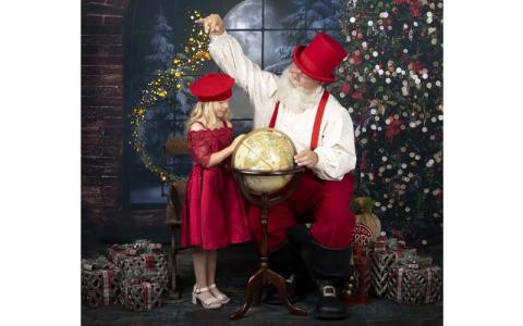 Photo/ Michelle Cochran.  Ellie Hatton poses with Santa Claus aka Tim Marks at Portraits by Michelle this Aug.
