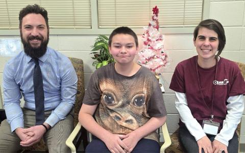 SMT photo/Sara Eisinger.  Principal Ryan McMahan (left to right), seventh-grade student Dakota and GEAR UP coordinator Taylor Rae Dodge Brown at Swain Middle School Tuesday afternoon. Johnson was nominated as a recipient of the Victor E. Bell Scholarship recipient.