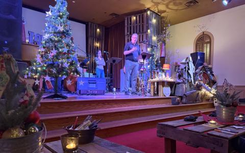 Submitted photo.  First Baptist Church of Bryson City pastor Dave Hawes speaks at Blue Christmas, an event hosted in collaboration with churches from the Swain Pastors Association, at Grove Church Sunday, Dec. 21. 