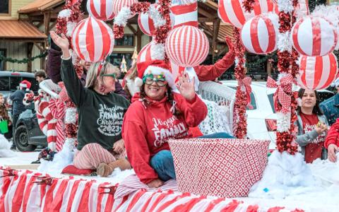 Photo/George Carter.  Tracie Edwards and Gina Wiggins ride The Wiggins Family Candy Cane Lane float through town during the Annual Bryson City Christmas Parade Saturday afternoon.