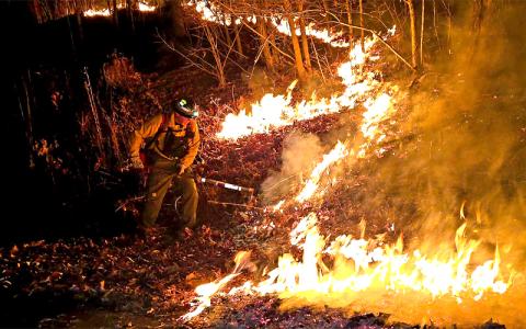 SMT photo/Sara Eisinger.  Fire crews from West Swain Fire Department and North Carolina Forest Service respond to a brush fire at Deer Ridge Road and Marr Creek off Highway 28 South on the evening of Dec. 21, only to return the next morning. 