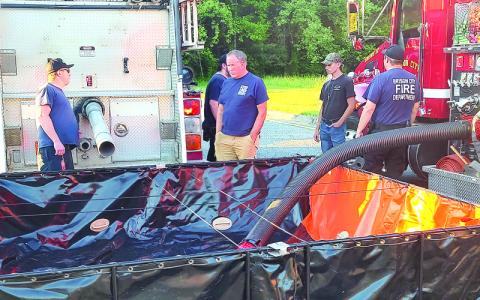 Photo/Charles Bryson.  Bryson City Fire Department members practice fire scene setup for North Carolina Office of State Fire Marshal inspection in the Ingles Market parking lot.
