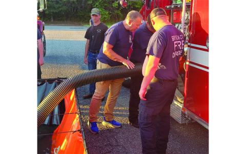 Photo/Charles Bryson.  Bryson City firefighters practice fire scene setup for North Carolina Office of State Fire Marshal inspection in the Ingles Market parking lot May 6. 