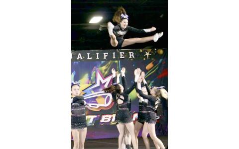Submitted photo.  Emma Adams goes airbound in a basket toss at the Spirit Brands Patriot Championship in Knoxville Jan. 10.