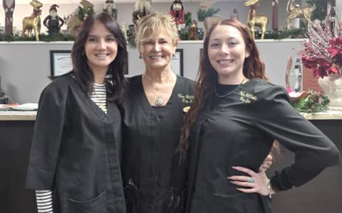 SMT photo/Sara Eisinger.  New Attitudes Day Spa’s Aliyah Stewart (left to right), Nancy Jones, owner, and Grace Cabe start the day with matching smiles Dec. 30. 