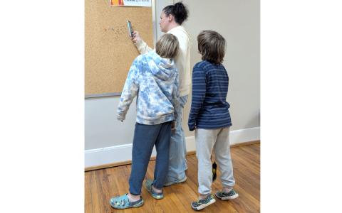 Photo/Amber Johnston. Volunteer Leader Lauren Wagonner teaches the perception of ordinary objects using thumbtacks and shadows during the Explore 4-H: Photography Workshop Feb. 26.