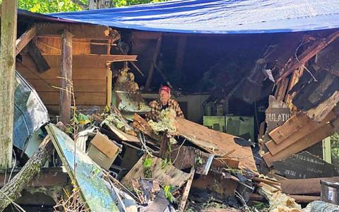 Photo/Sara Eisinger - US Navy Vet. Robert Pillow sits in his storm damaged home June 3.