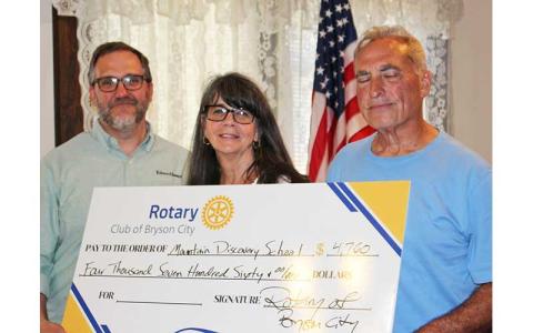 Photo/ Deb Stuart - Ted Goshorn (left to right), Billie Clemens and Nick Nichols hold literacy check for Mountain Discovery Charter School at the Historic Calhoun House June 4.