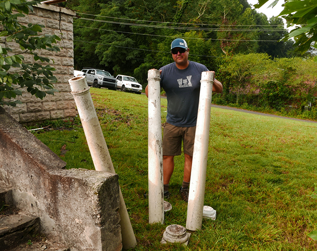 Tyler San Sauci, developer, is pictured with the historic wooden columns from the porch that were made locally most likely at the Bryson City Pump Works. The columns, as well as doors and some other items were salvaged.