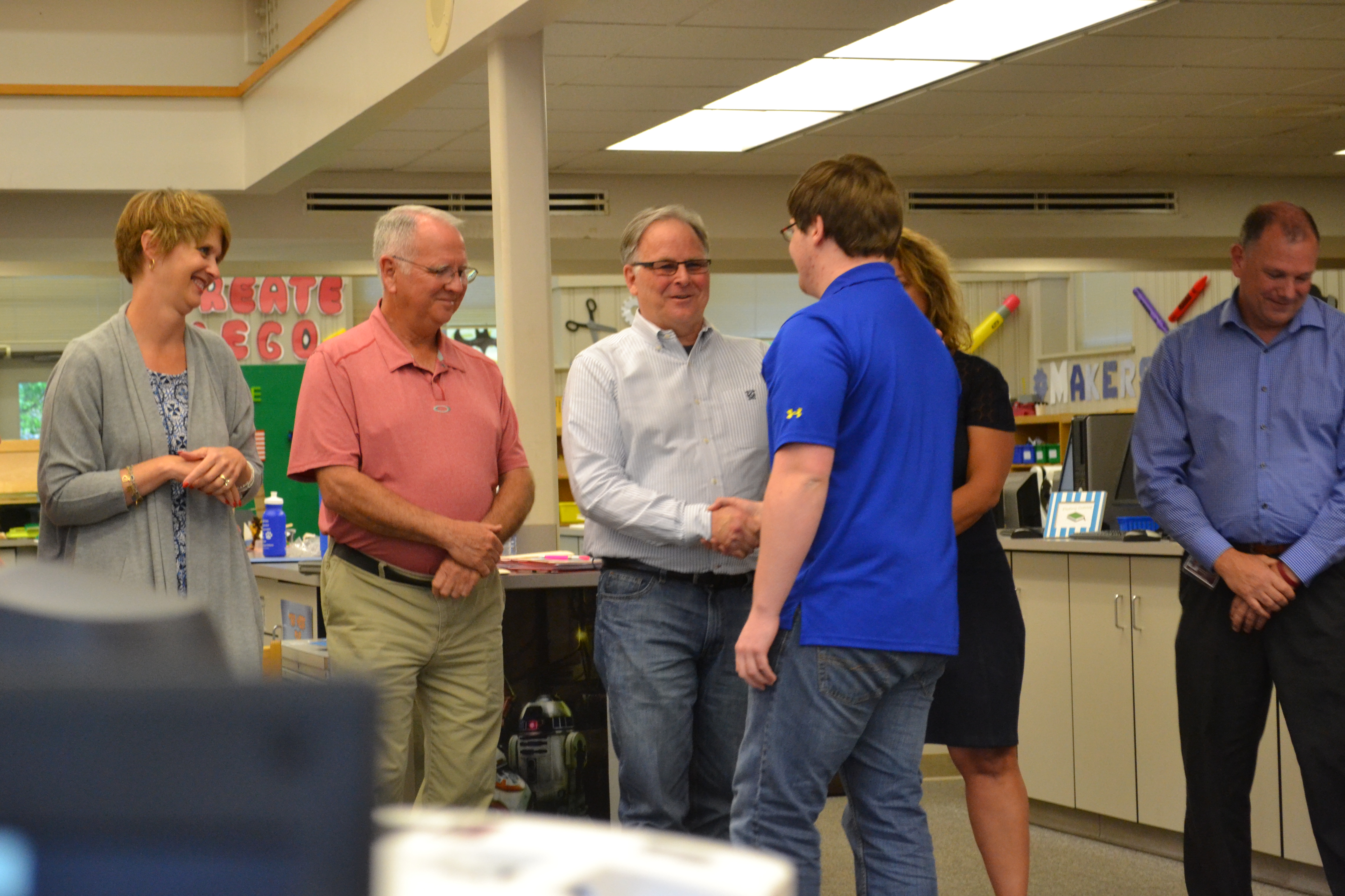Lambert Wilson, center, congratulates a student who was given a Character Award, with other School Board members during a meeting in the 2015-2016 school year.