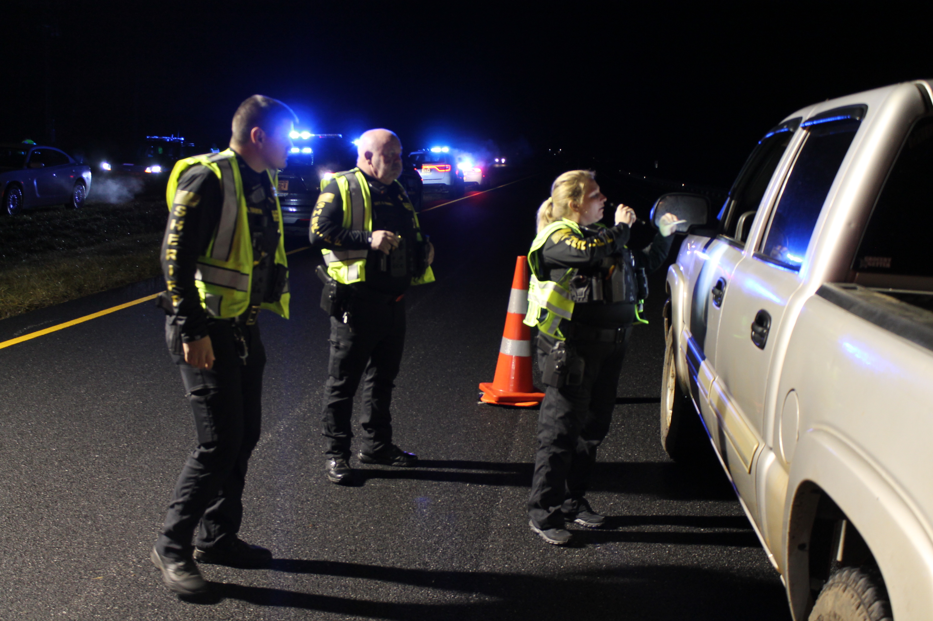 Swain County Sheriff's Office Deputy Barnes, along with Deputy Tabor and Sergeant Barnes check driver's licenses and tags during the multi-agency DWI checkpoint held on New Year's Eve that resulted in 27 citations.
