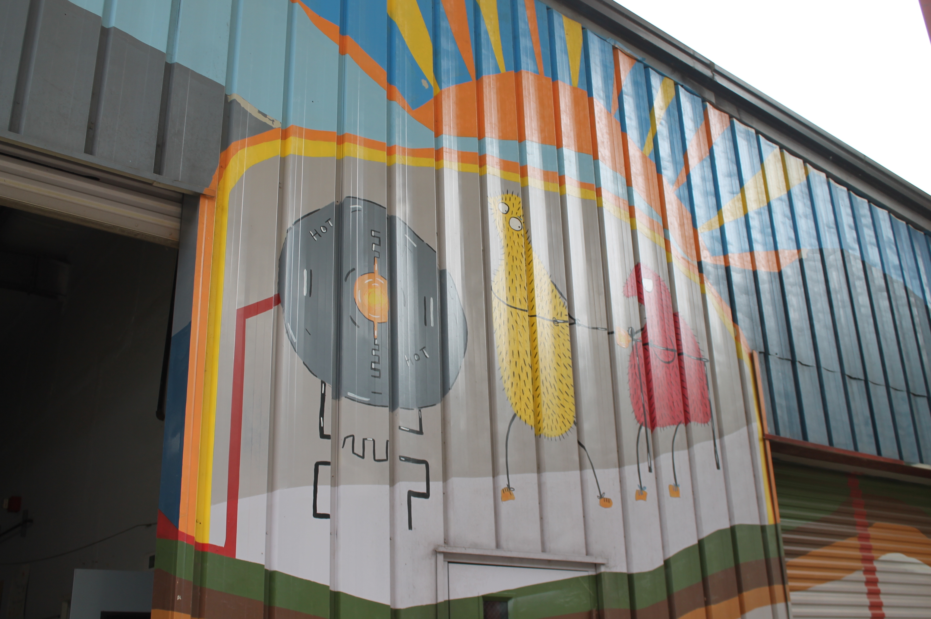 A colorful mural depicts the process by which gas is turned to energy to fuel the Green Energy Park.